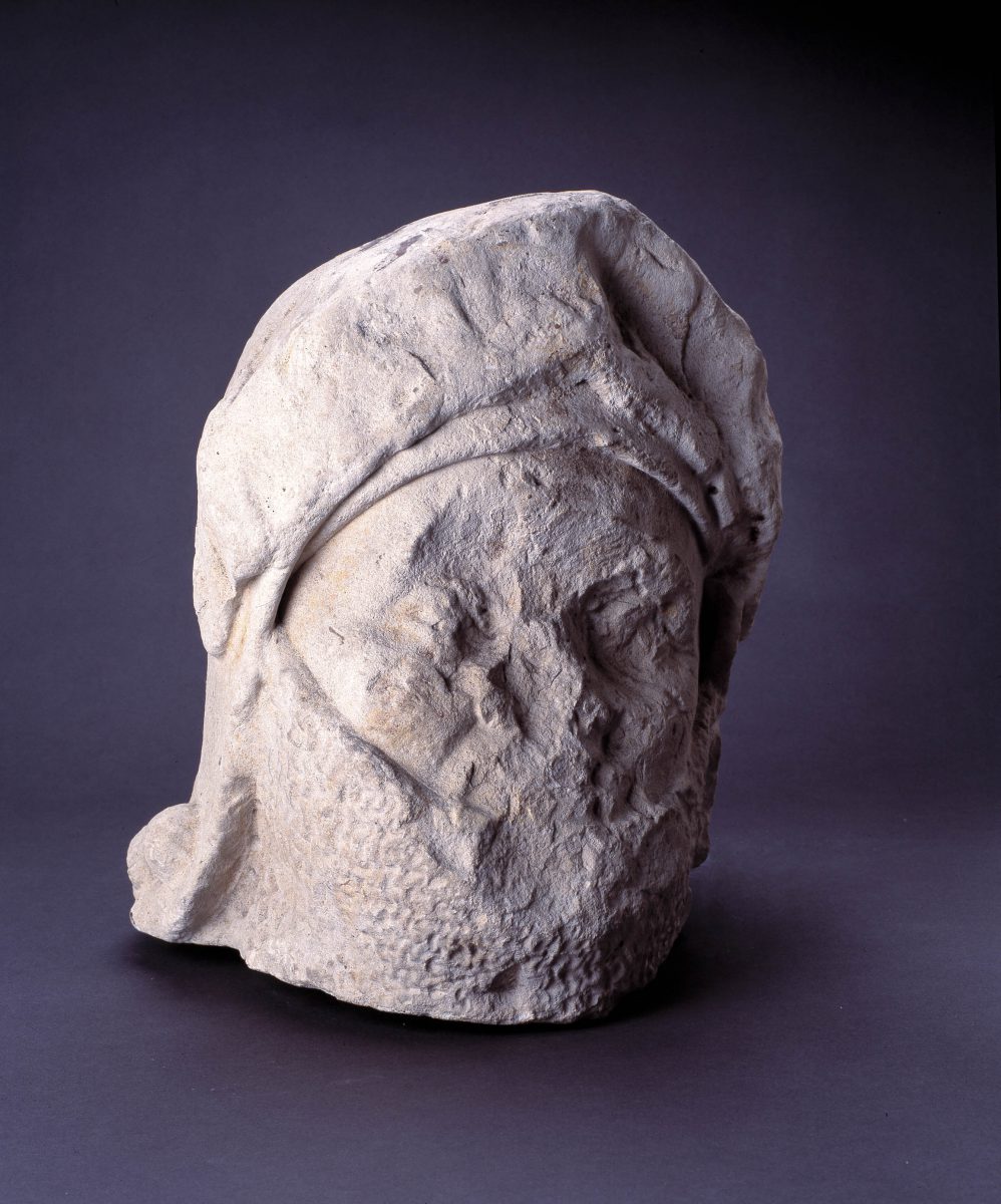 Helmeted head in stone